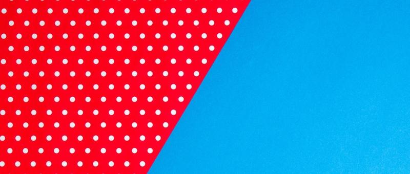 Red and white dotted material against blue background.
