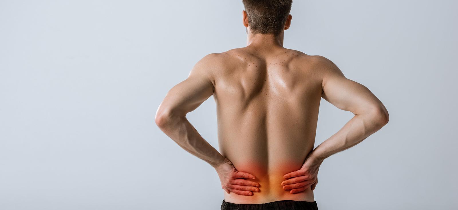 A man holding his lower back.