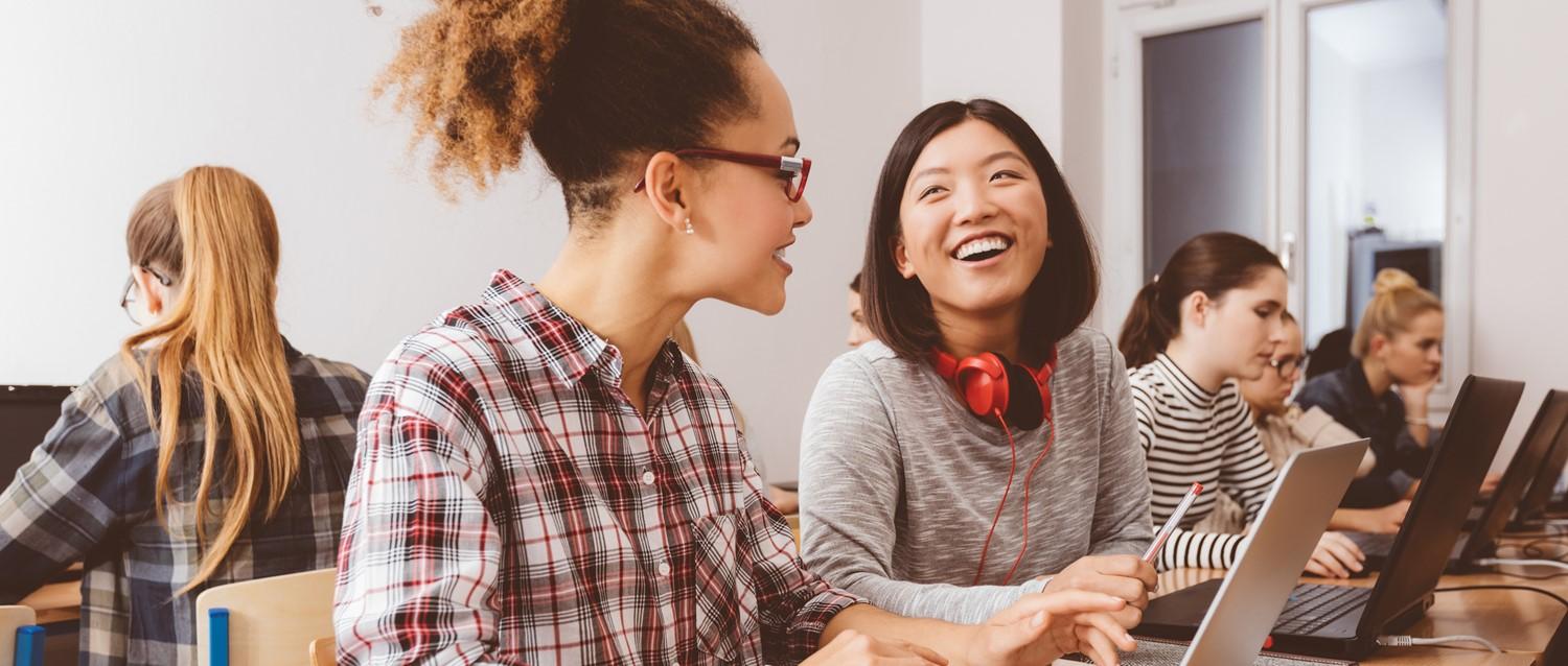 Teenagers studying together computers